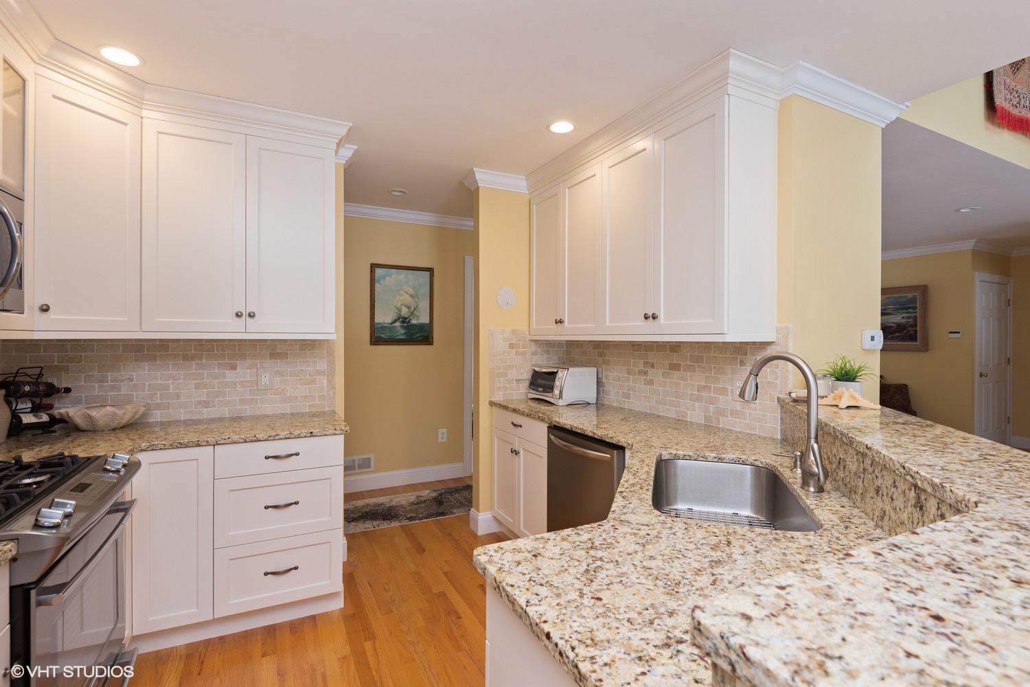 101 Reflection Drive Sandwich, MA 02563 - Photo 9 of 15 a kitchen with granite countertop a sink a stove and cabinets