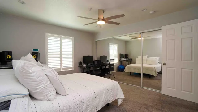 a bed room with a bed and a large window