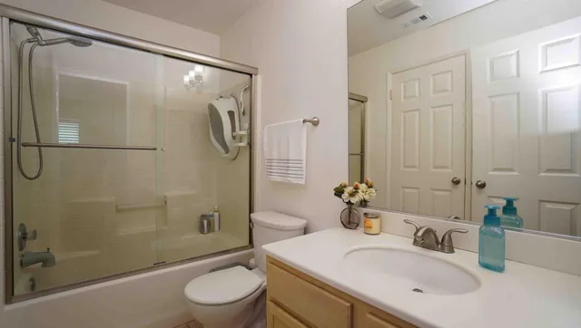 a bathroom with a sink toilet and shower