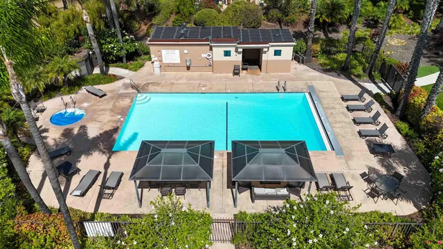 an aerial view of a house with swimming pool garden and patio