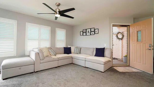 a living room with furniture and a large window