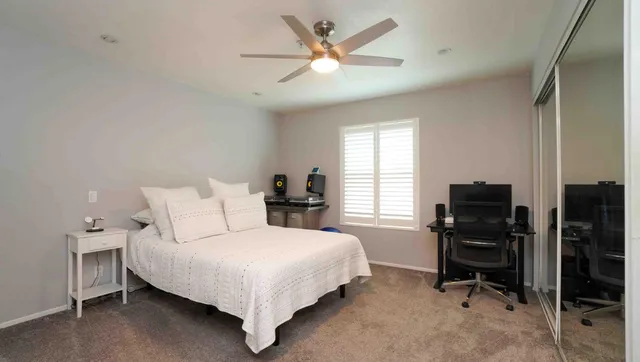 a bedroom with a bed and a desk