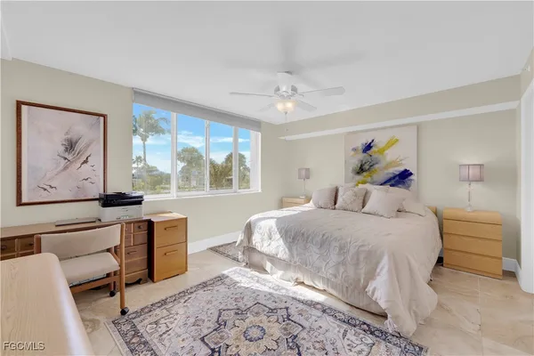 a spacious bedroom with a bed and a view of bathroom