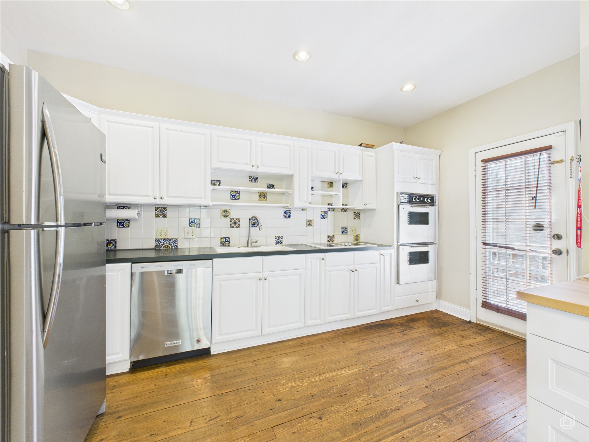 451 High Gabriel East Leander, TX 78641 - Photo 18 of 40 a kitchen with stainless steel appliances a refrigerator sink and cabinets