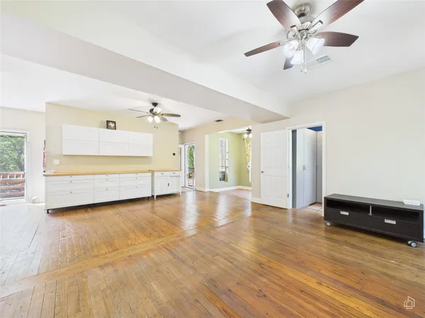 a view of a kitchen with wooden floor and a kitchen space