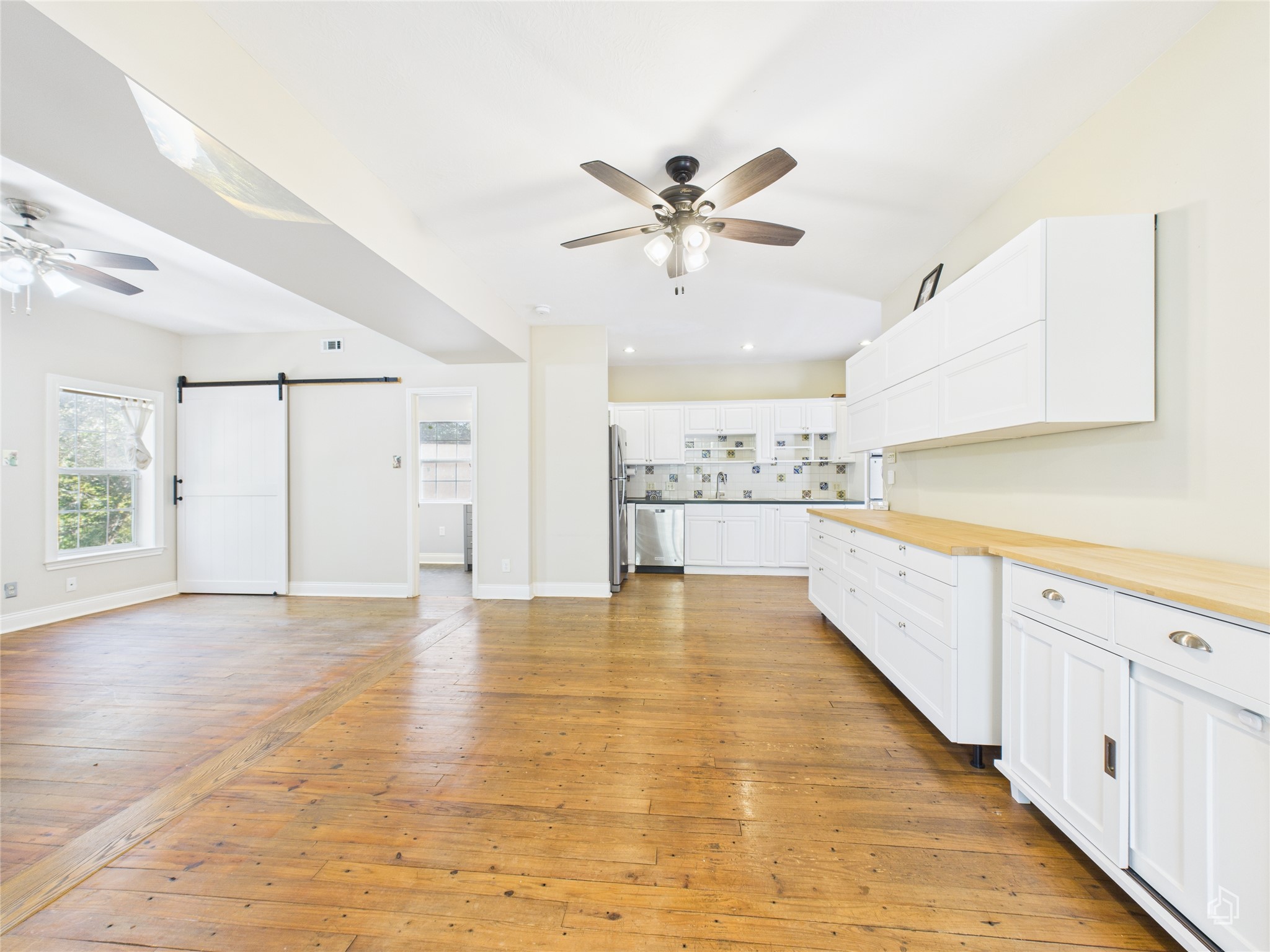 451 High Gabriel East Leander, TX 78641 - Photo 20 of 40 a view of a kitchen with wooden floor and a kitchen space