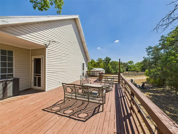 a view of balcony with furniture and wooden floor