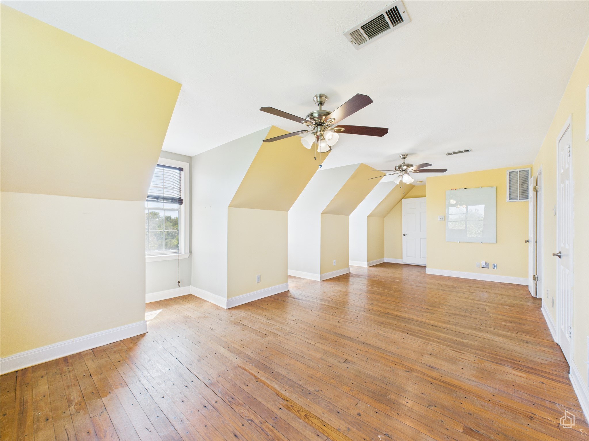 451 High Gabriel East Leander, TX 78641 - Photo 27 of 40 an empty room with wooden floor fan and windows