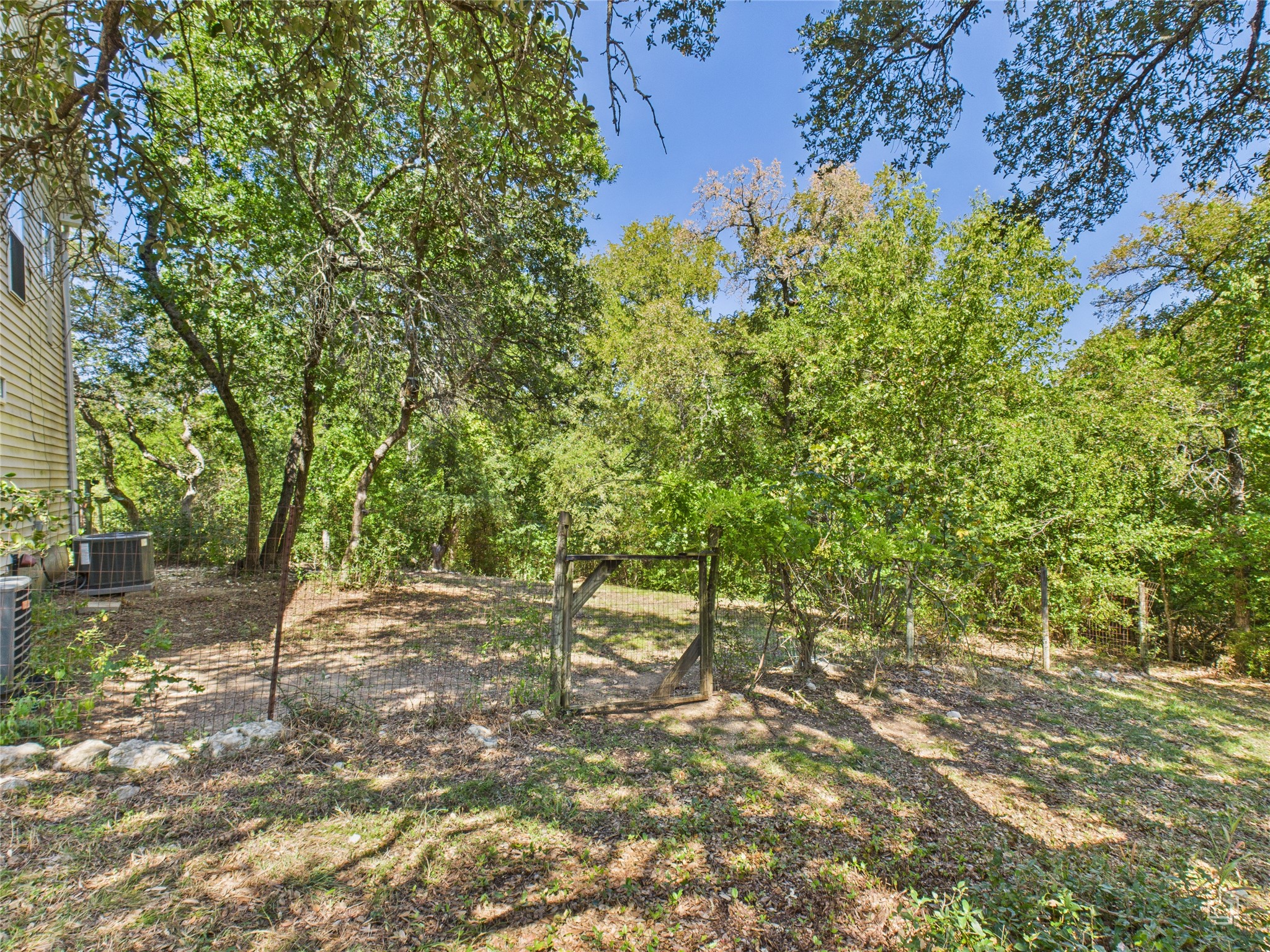 451 High Gabriel East Leander, TX 78641 - Photo 35 of 40 a backyard of a house with large trees and plants