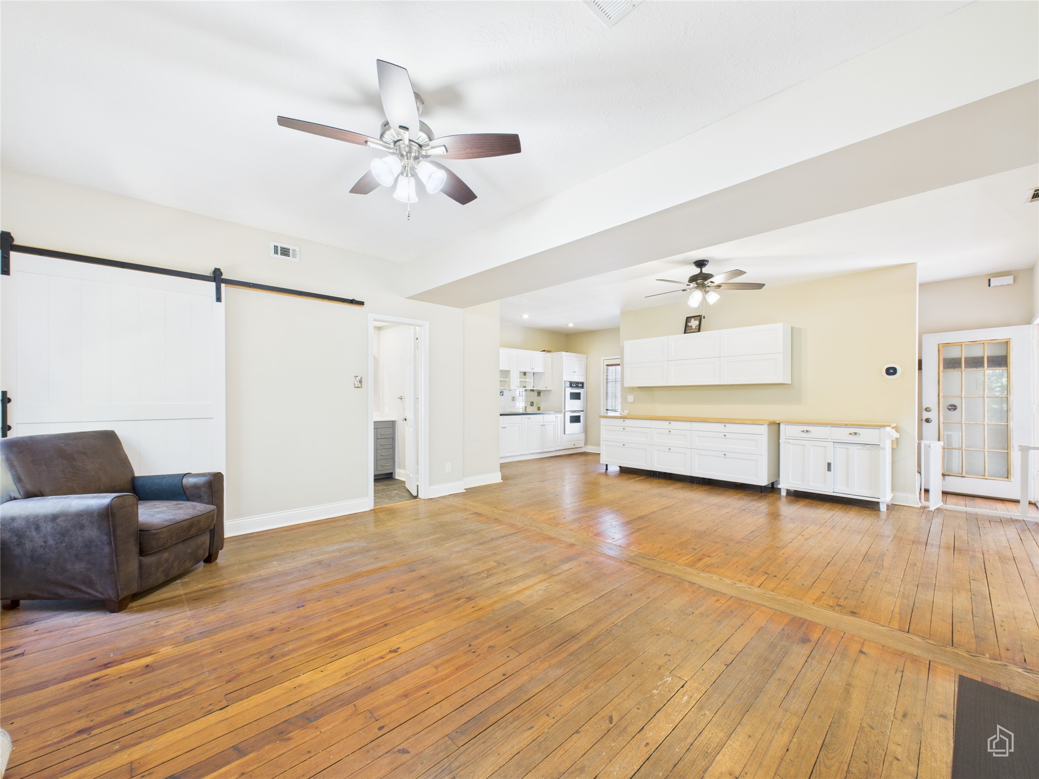 451 High Gabriel East Leander, TX 78641 - Photo 4 of 40 a view of a livingroom with furniture a ceiling fan and wooden floor