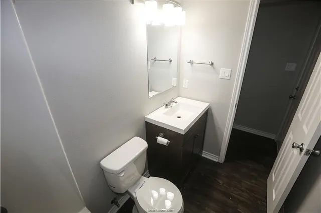 a white toilet sitting next to a bathroom sink