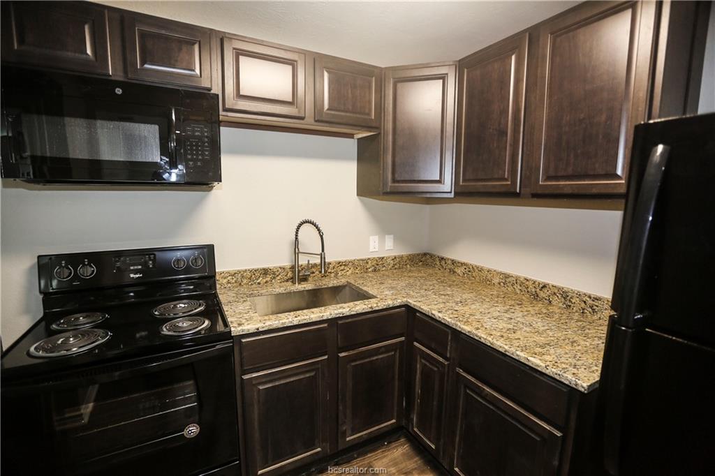 814 Mitchell Street Bryan, TX 77802 - Photo 3 of 14 a kitchen with granite countertop stainless steel appliances and sink