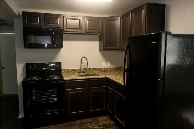 a kitchen with a sink and stainless steel appliances