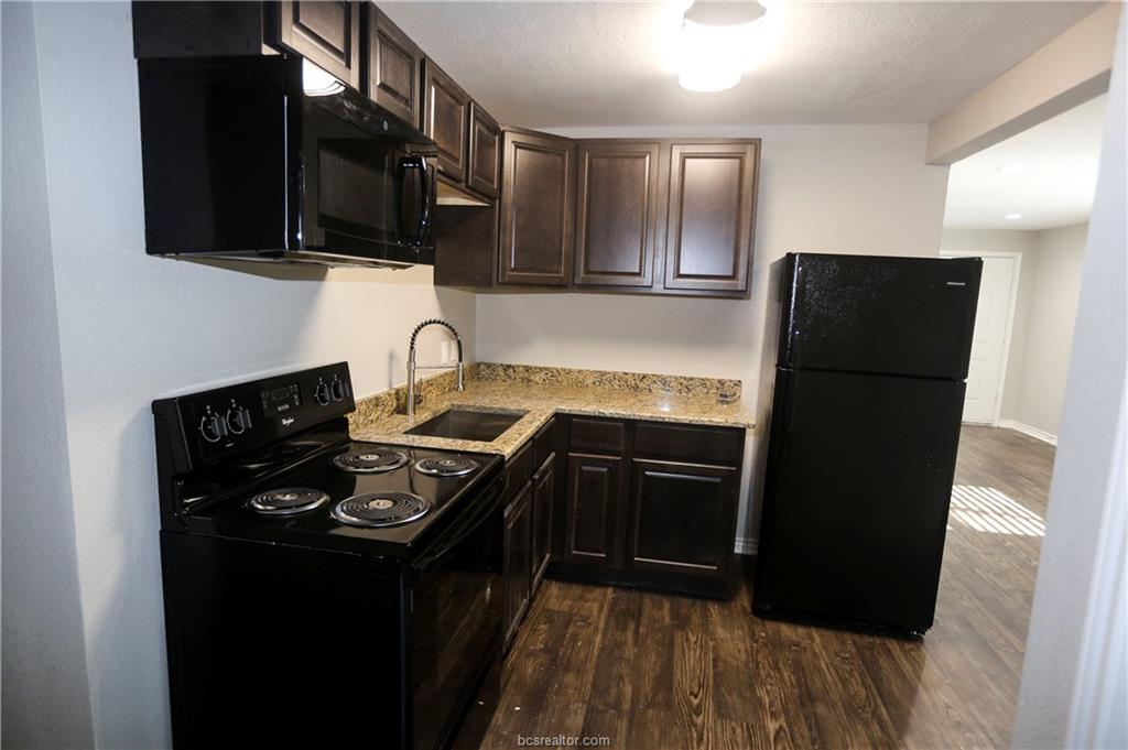 814 Mitchell Street Bryan, TX 77802 - Photo 5 of 14 a kitchen with a sink stove and refrigerator
