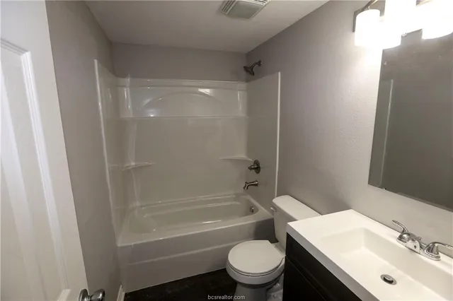 a bathroom with a sink mirror toilet and bathtub