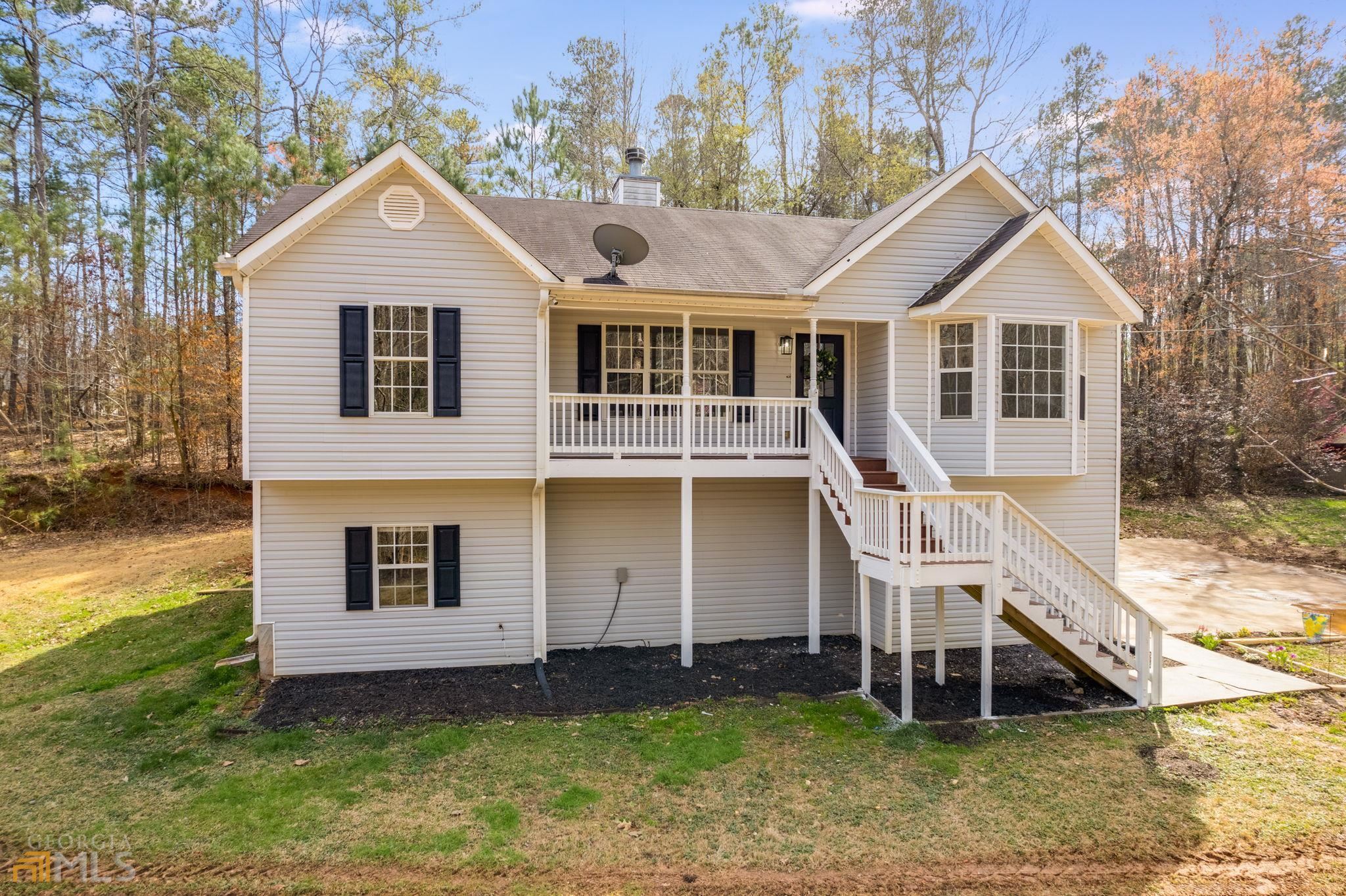 7778 Post Road Winston, GA 30187 - Photo 1 of 1 a front view of a house with a yard and garage