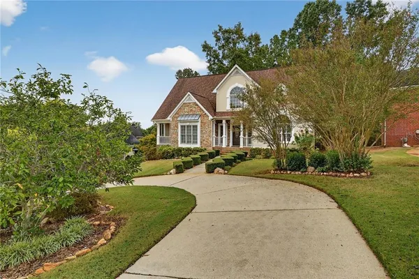 a front view of a house with a yard
