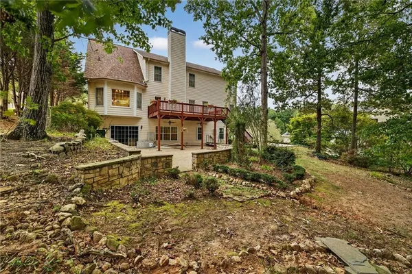 a backyard of a house with table and chairs
