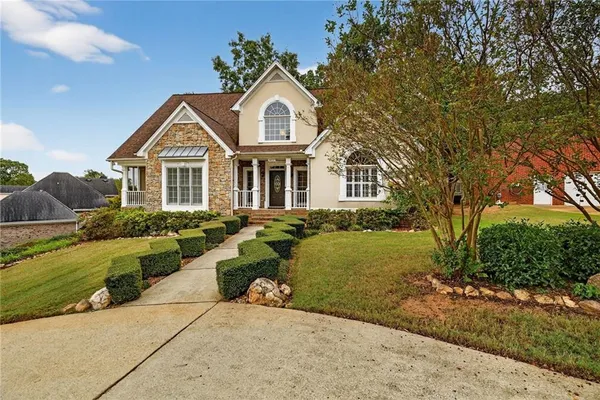 a front view of a house with a yard