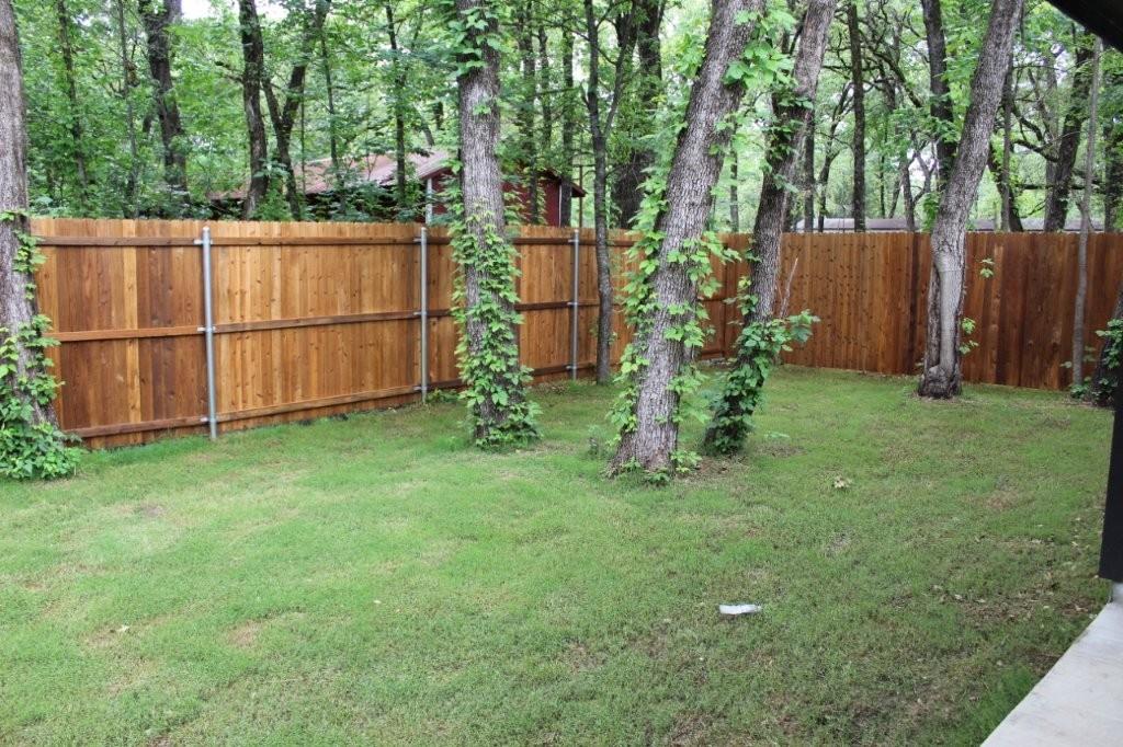 125 Chapperall Drive Mabank, TX 75156 - Photo 4 of 11 a view of backyard with wooden fence and a bench
