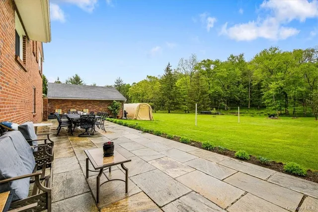 a view of a patio with table and chairs and potted plants