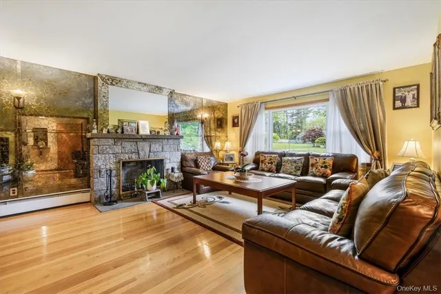 a living room with furniture large window and a fireplace