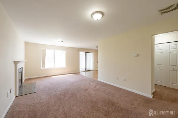 an empty room with windows and closet