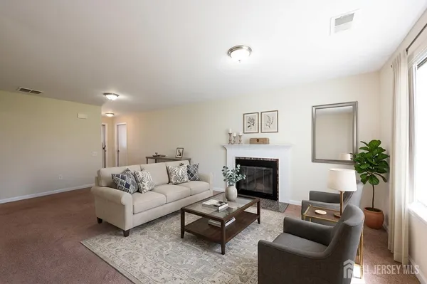 a living room with furniture and a fireplace