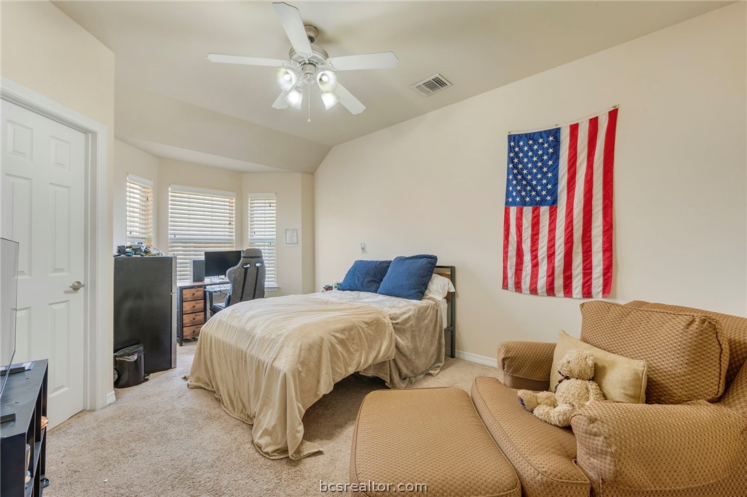 1198 Jones-Butler Road, Unit 1002 College Station, TX 77840 - Photo 12 of 18 a bedroom with a bed and a couch