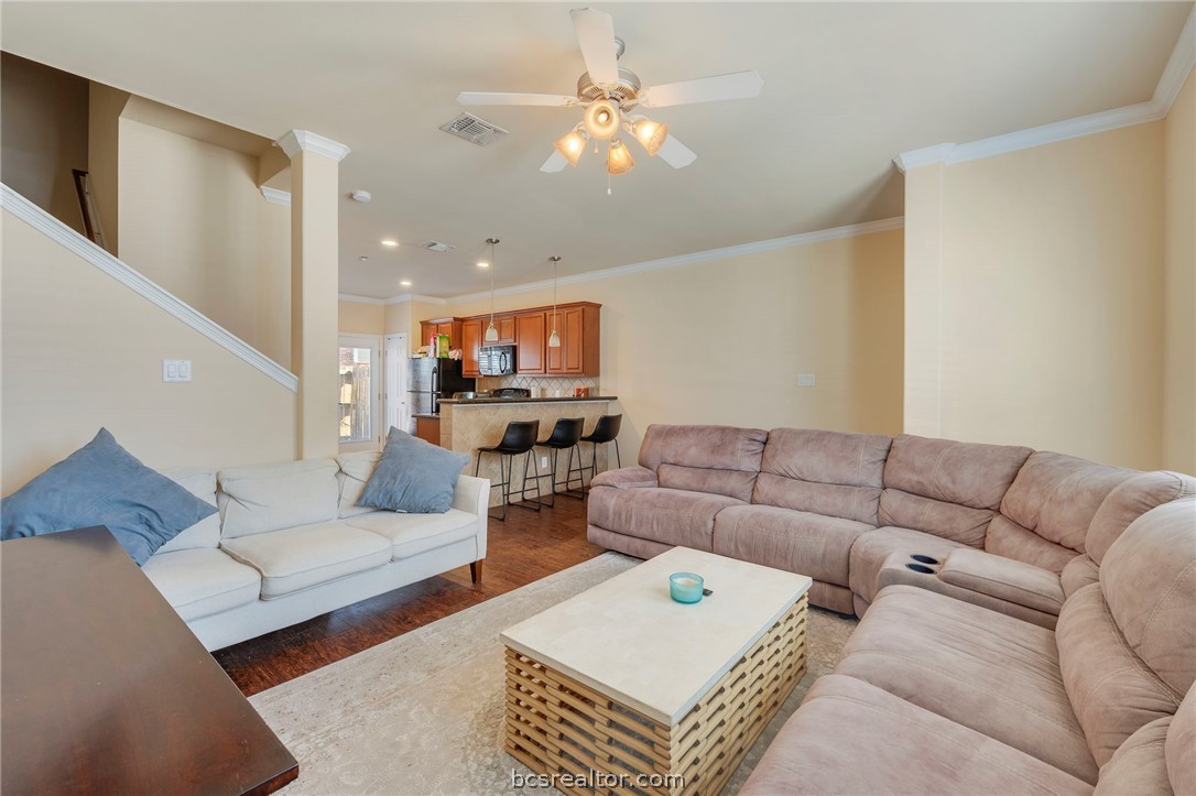 1198 Jones-Butler Road, Unit 1002 College Station, TX 77840 - Photo 2 of 18 a living room with furniture ceiling fan and a rug