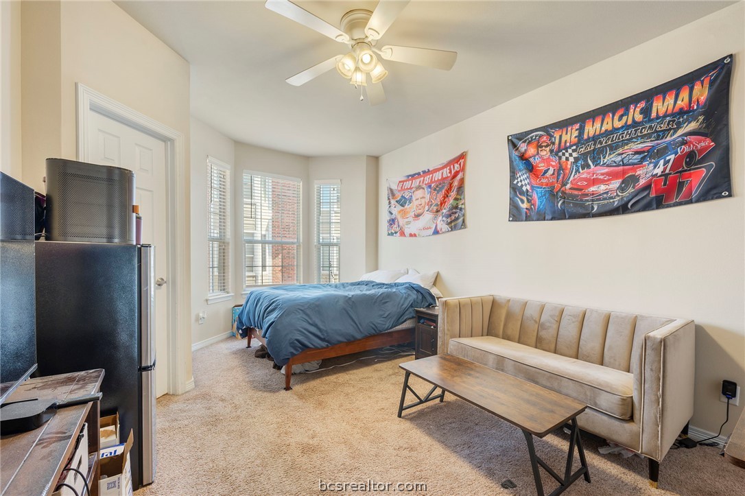 1198 Jones-Butler Road, Unit 1002 College Station, TX 77840 - Photo 8 of 18 a bedroom with furniture and a window