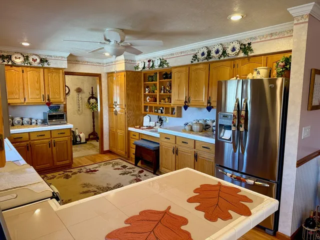 a living room with furniture and a large mirror next to a window