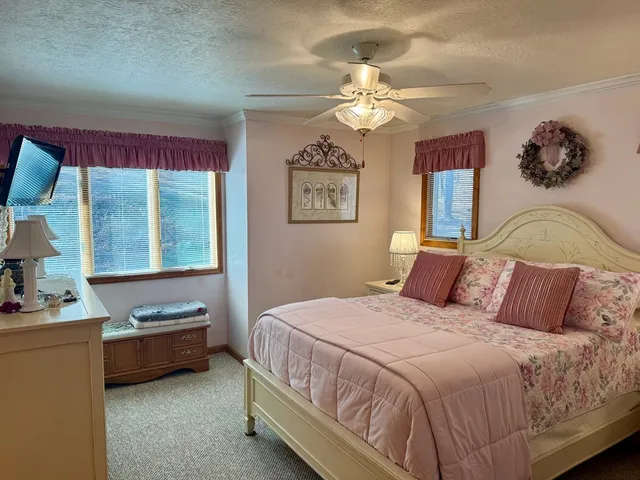 a bedroom with a bed and dresser