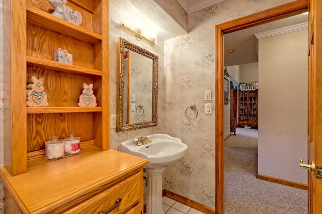 a front view of house with yard and trees around