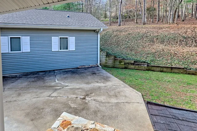 a front view of a house with a yard and trees