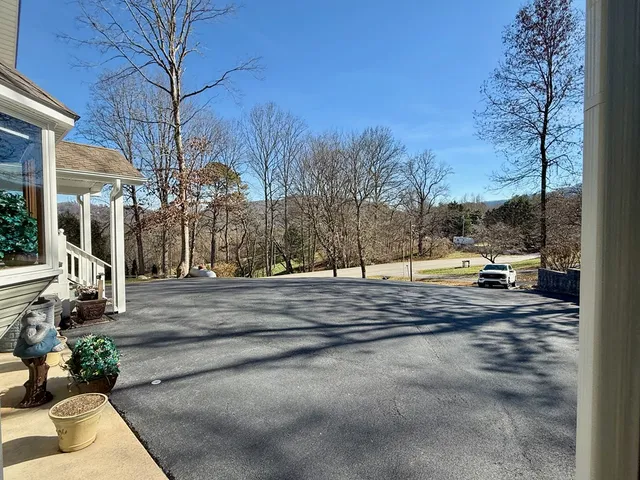 a kitchen with stainless steel appliances granite countertop table chairs sink refrigerator and microwave