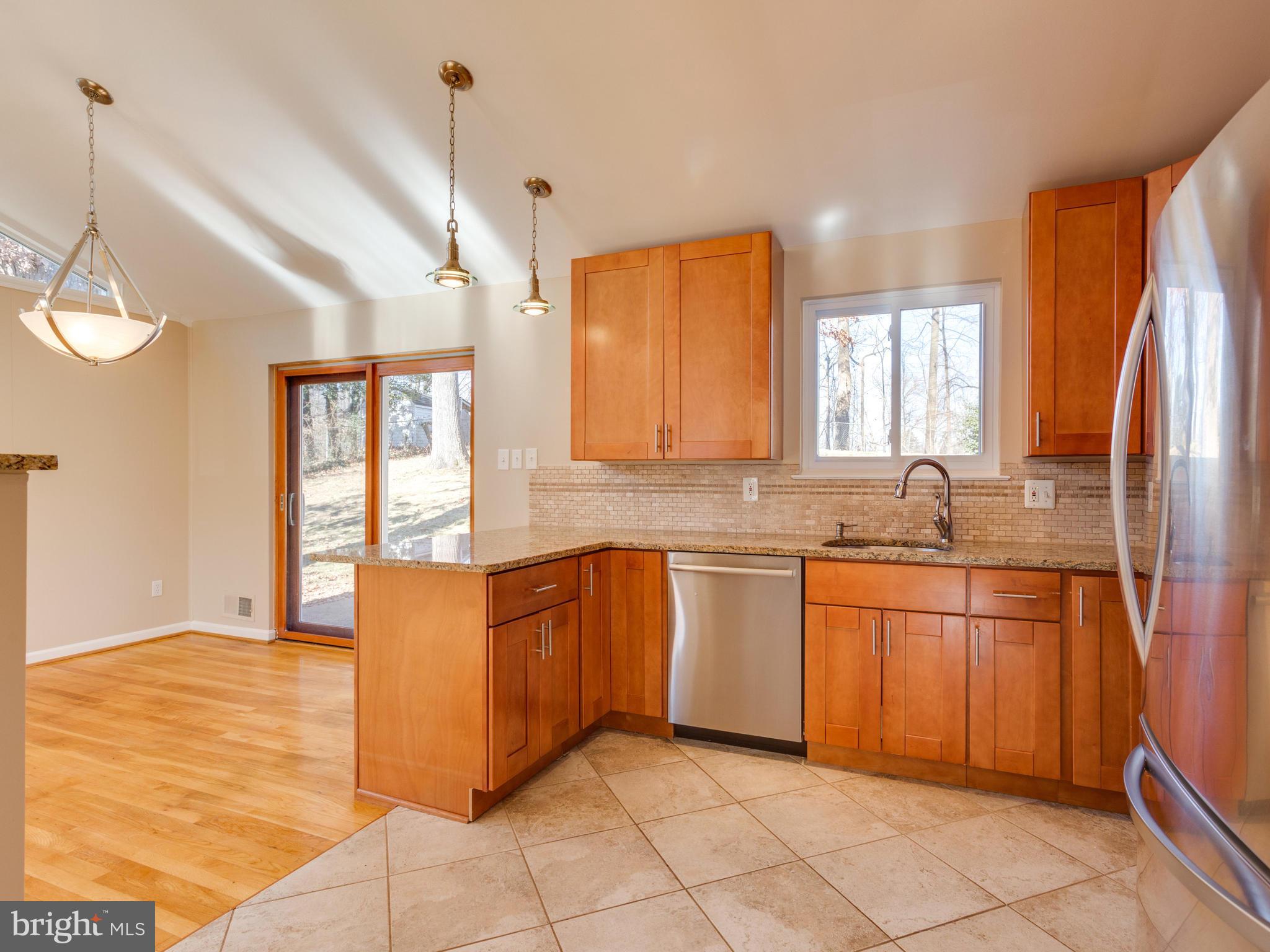 8702 Victoria Road Springfield, VA 22151 - Photo 7 of 27 a kitchen with granite countertop sink and cabinets