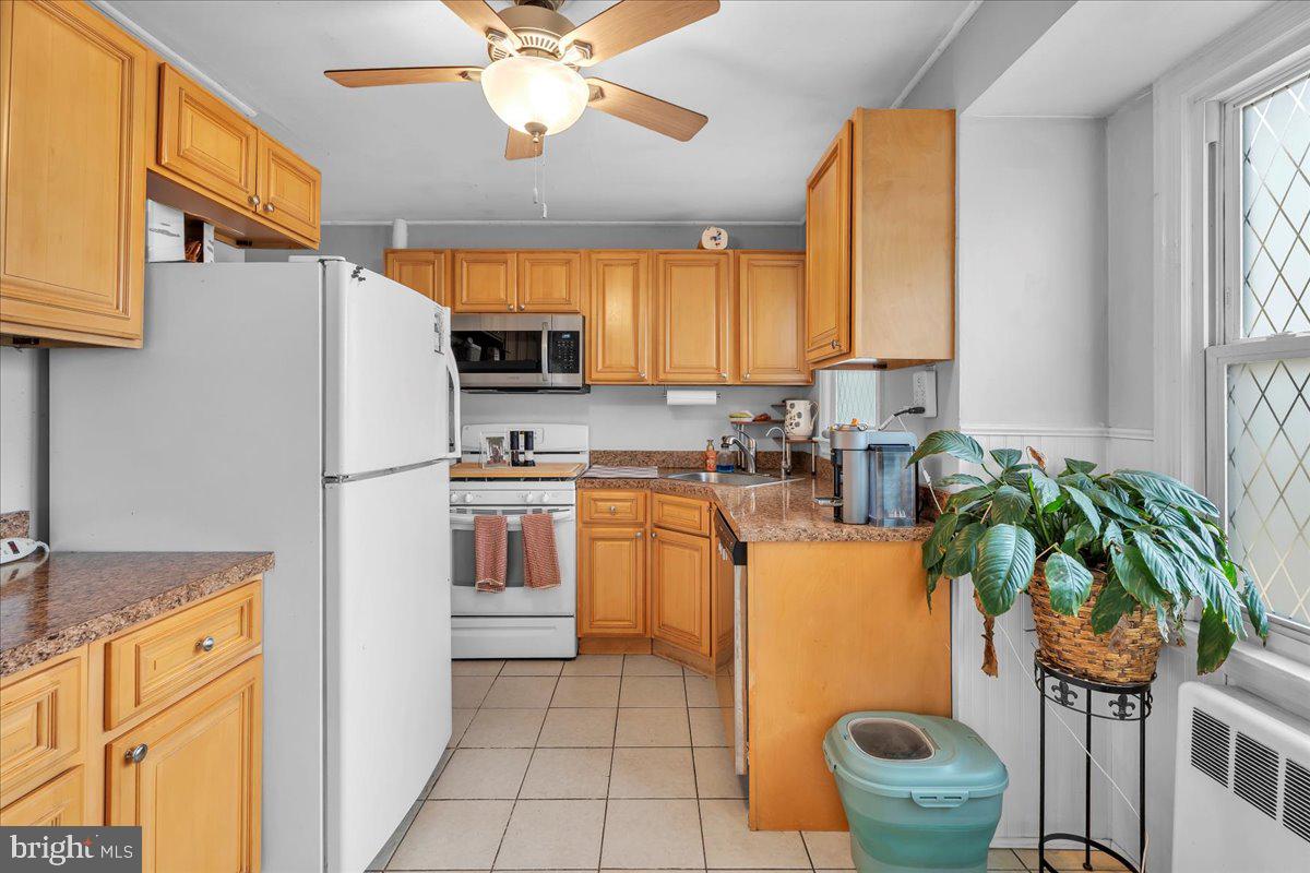 54 West Browning Road Bellmawr, NJ 08031 - Photo 11 of 25 a kitchen with a refrigerator a stove a sink and a counter