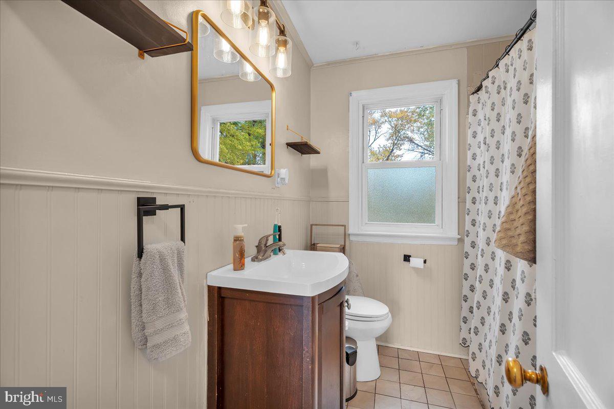 54 West Browning Road Bellmawr, NJ 08031 - Photo 14 of 25 a bathroom with a sink a toilet and shower