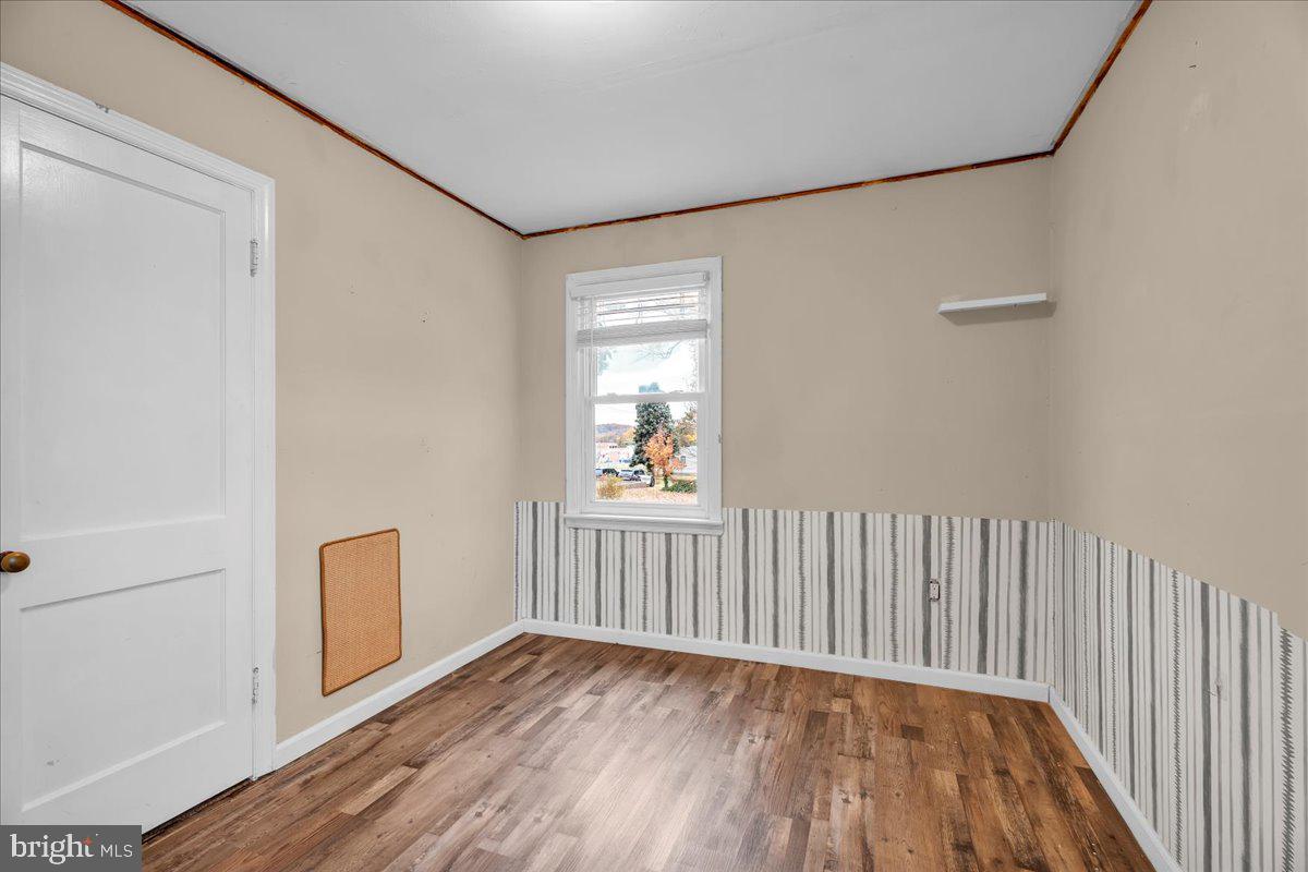 54 West Browning Road Bellmawr, NJ 08031 - Photo 16 of 25 a view of an empty room with wooden floor and a window
