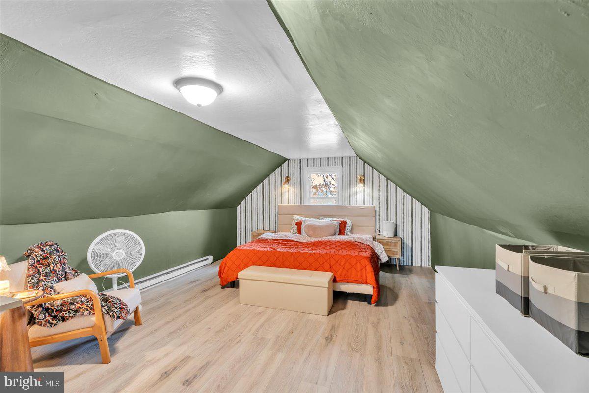 54 West Browning Road Bellmawr, NJ 08031 - Photo 17 of 25 a bedroom with a bed and wooden floor