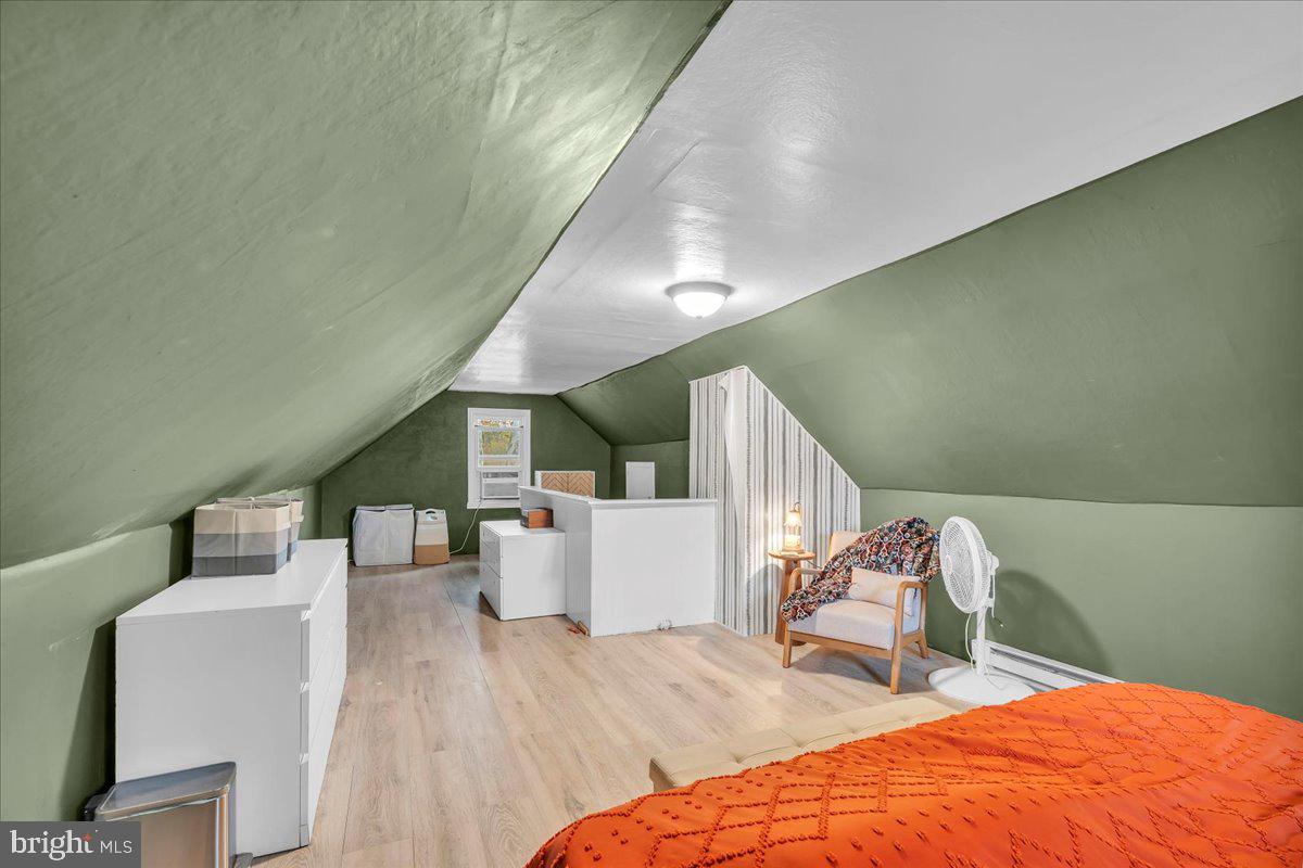 54 West Browning Road Bellmawr, NJ 08031 - Photo 18 of 25 a bedroom with a bed and a wooden floor