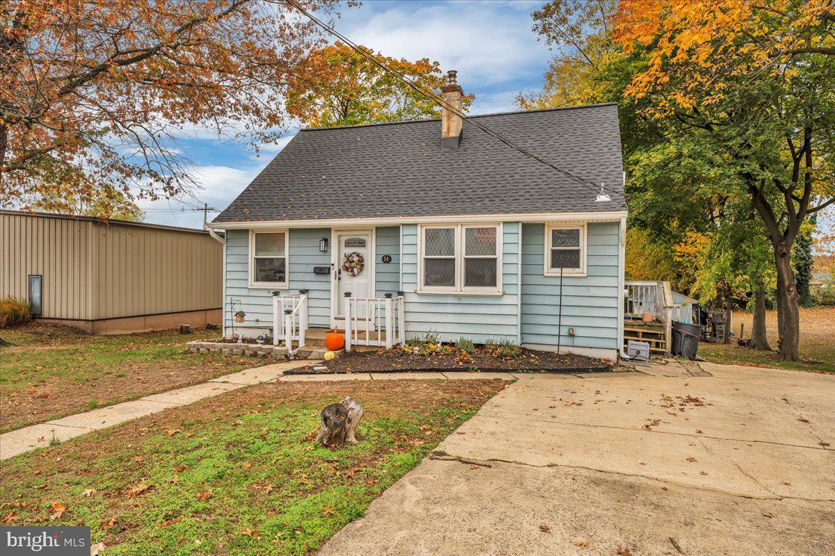 54 West Browning Road Bellmawr, NJ 08031 - Photo 3 of 25 a backyard of a house with large trees and buildings