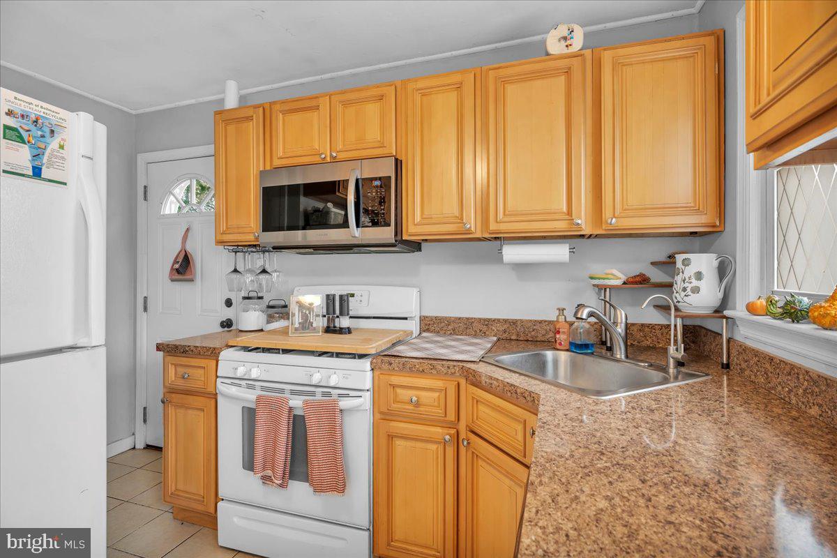 54 West Browning Road Bellmawr, NJ 08031 - Photo 9 of 25 a kitchen with a stove a sink and a microwave