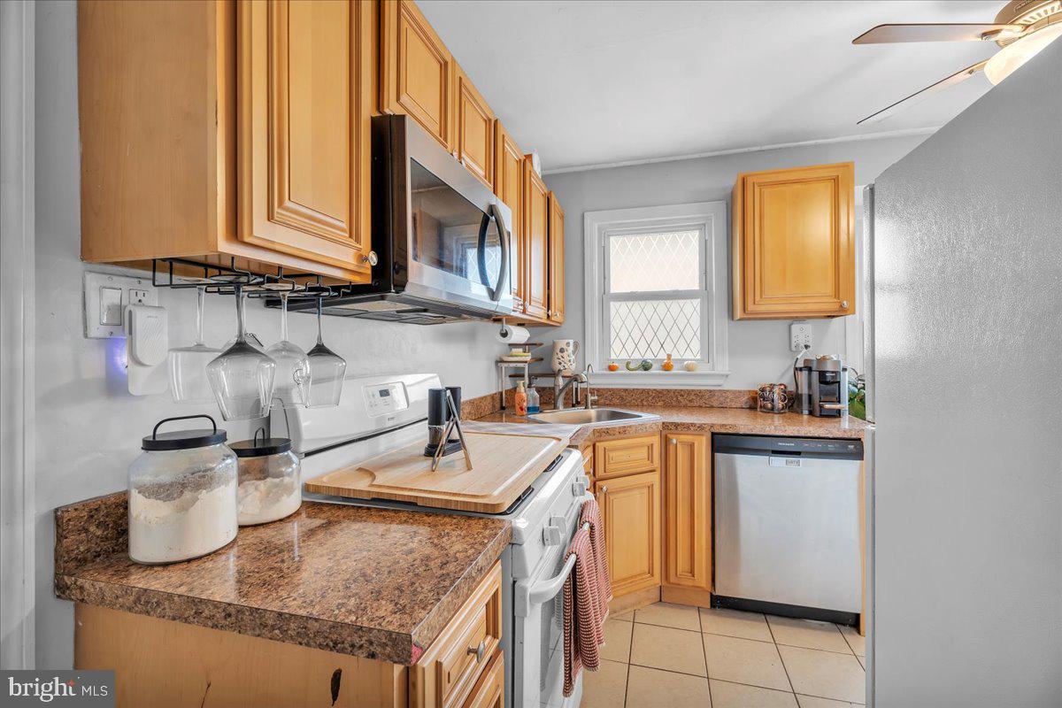 54 West Browning Road Bellmawr, NJ 08031 - Photo 10 of 25 a kitchen with granite countertop a sink a stove and cabinets