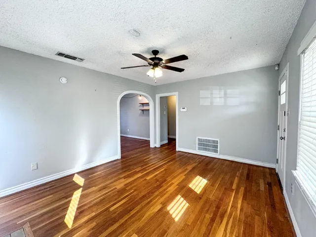 wooden floor in an empty room with a window