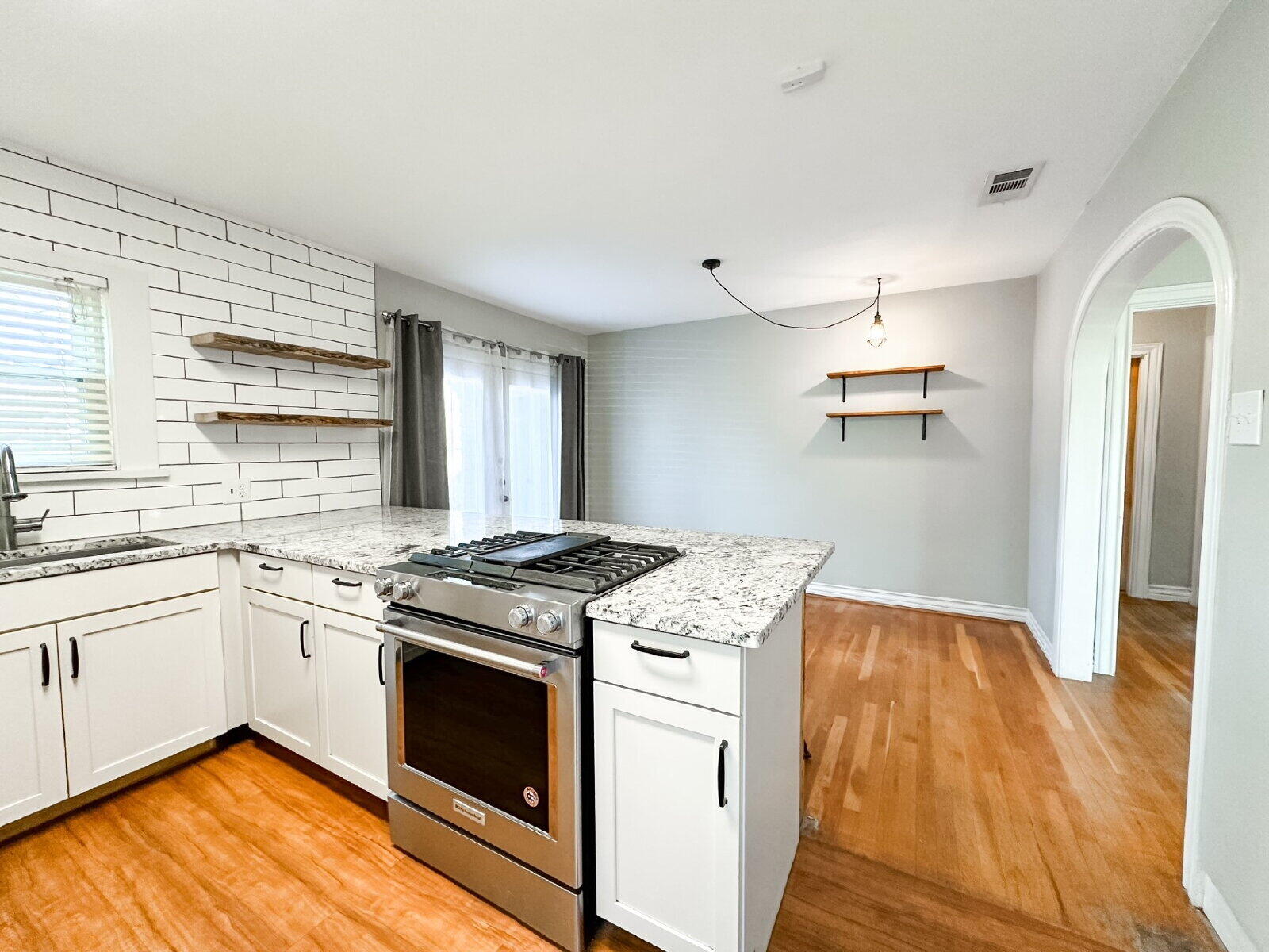 2622 25th Street Lubbock, TX 79410 - Photo 7 of 12 a kitchen with a stove and a wooden floor