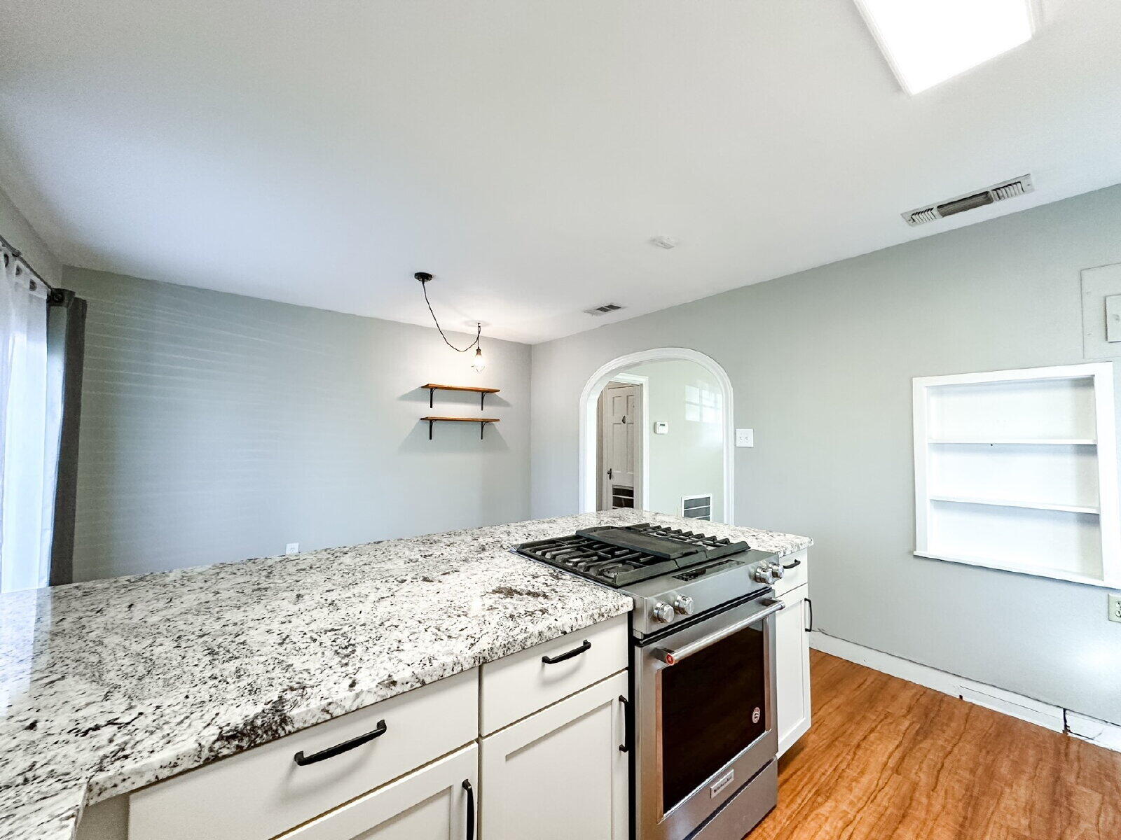 2622 25th Street Lubbock, TX 79410 - Photo 8 of 12 a kitchen with a stove and a wooden floor