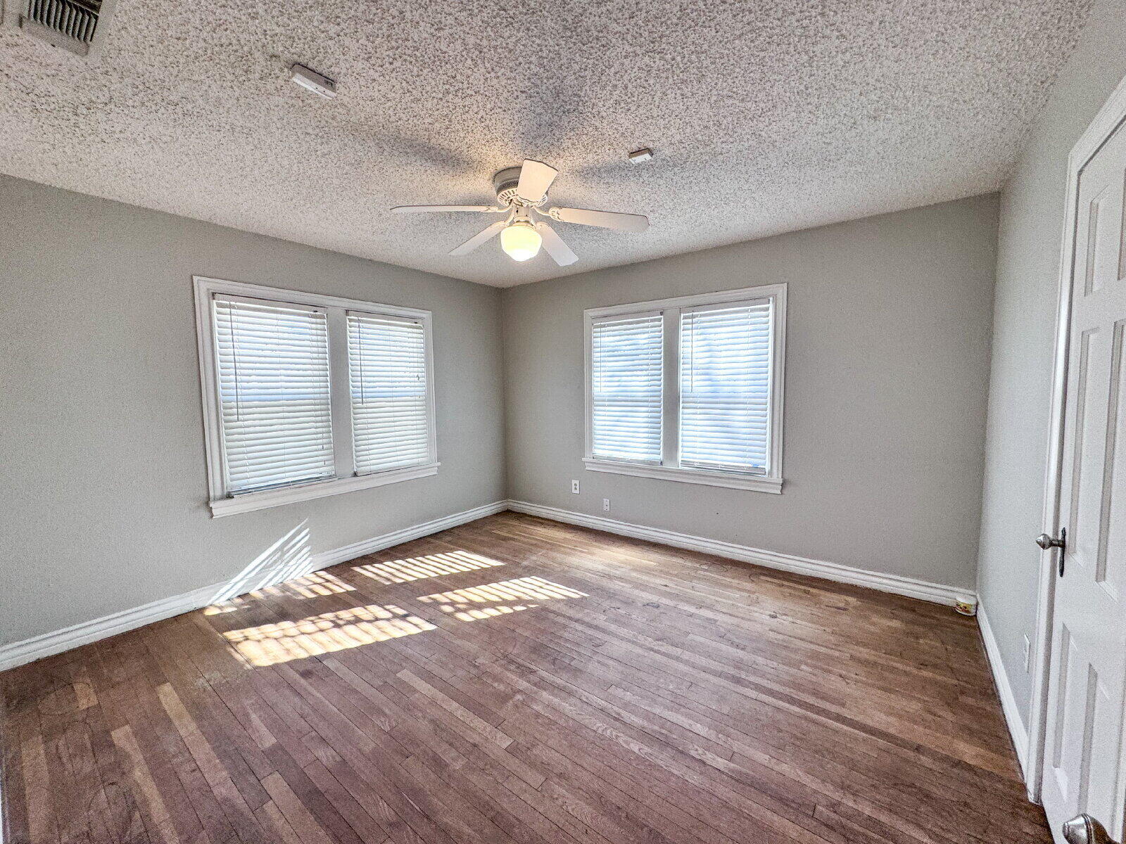 2622 25th Street Lubbock, TX 79410 - Photo 9 of 12 wooden floor in an empty room with a window