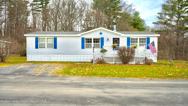 a front view of house with yard outdoor seating and barbeque oven